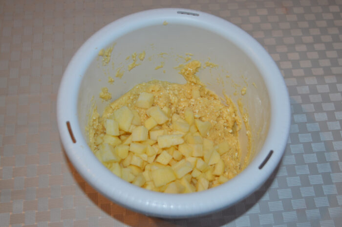 Folding apple cubes into the cottage cheese cake batter