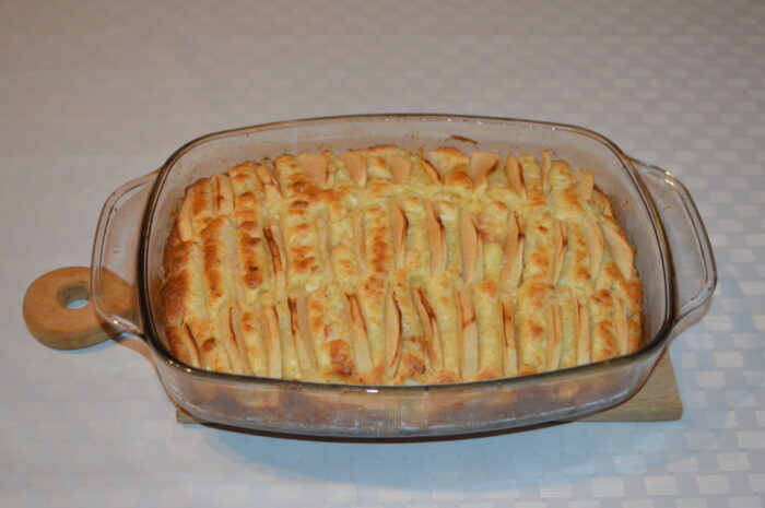 Cake in the oven loosely covered with foil to prevent over-browning