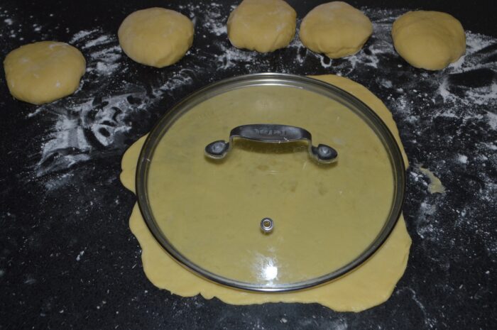 Thin round sheet of dough cut using a plate as a template