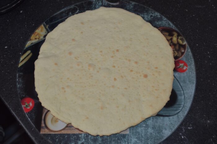 Baked cake layers on a cooling rack, lightly golden around the edges