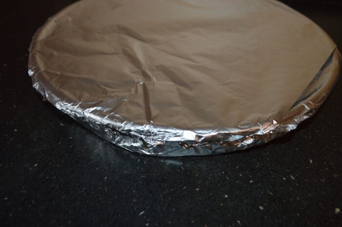 Pan wrapped in aluminum foil and placed in the oven for long, slow baking