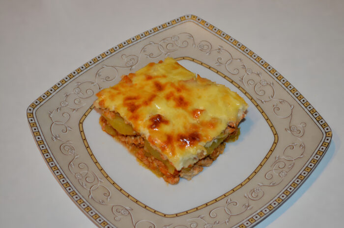 Slices of potato moussaka with ground chicken served on a plate