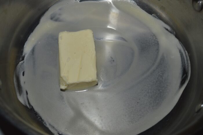 Butter melting in a small saucepan over low heat