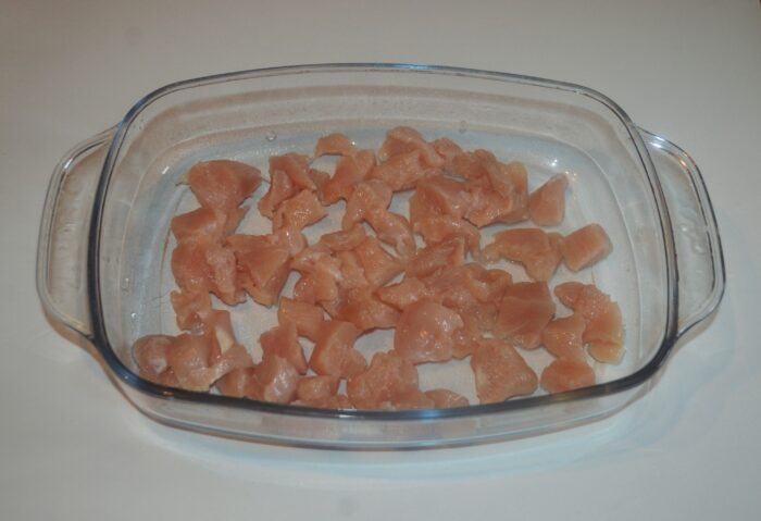 Finely chopped chicken breast spread in a baking dish