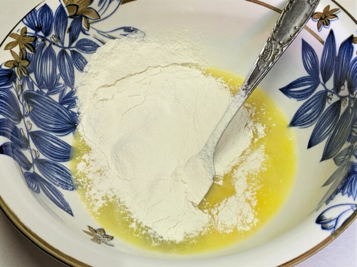 Beaten eggs mixed with flour and salt for homemade noodle dough
