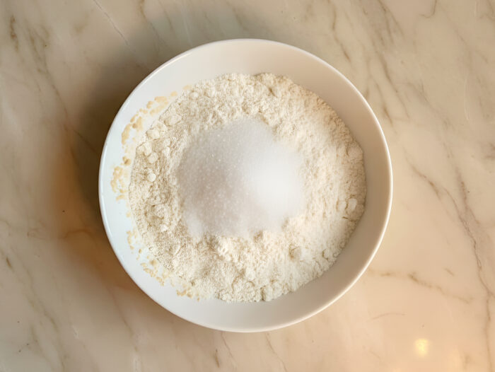 Dry ingredients (flour, sugar, salt) mixed in a large bowl