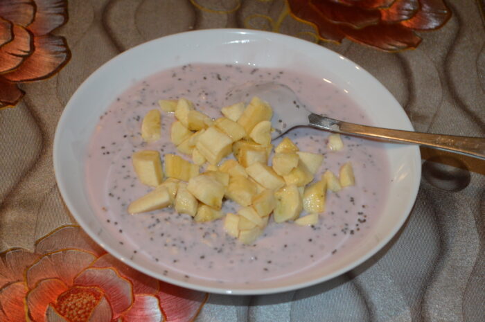 Folding finely chopped banana into the chia