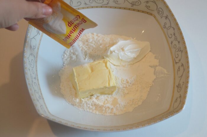 Vanilla sugar and salt sprinkled over the dough ingredients in the bowl