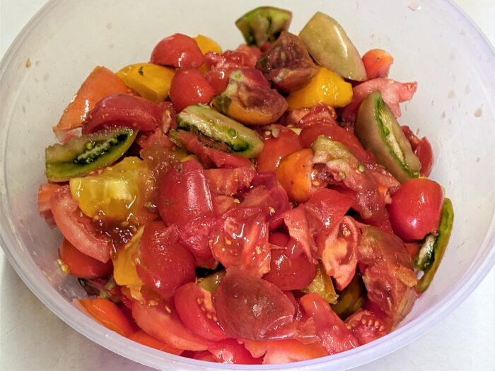 Fresh chopped tomatoes simmering in a pot on the stove