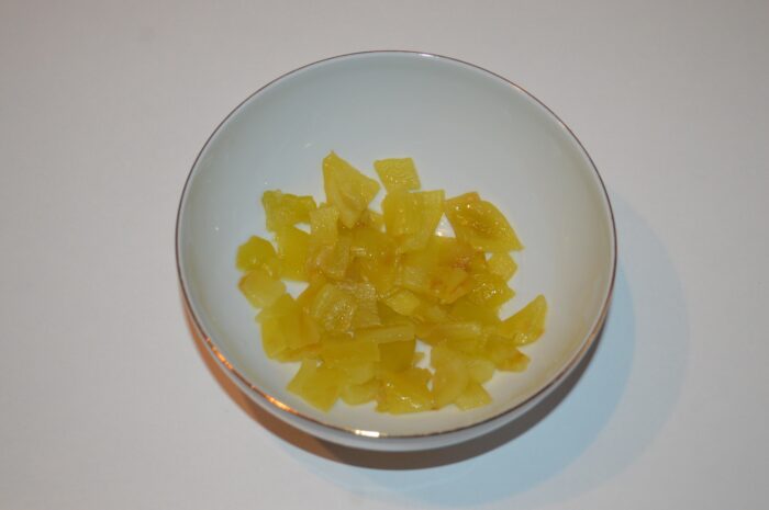 Peeled roasted red pepper on a board, seeds removed and finely chopped