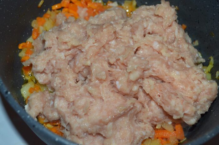 Raw ground chicken added to the pot