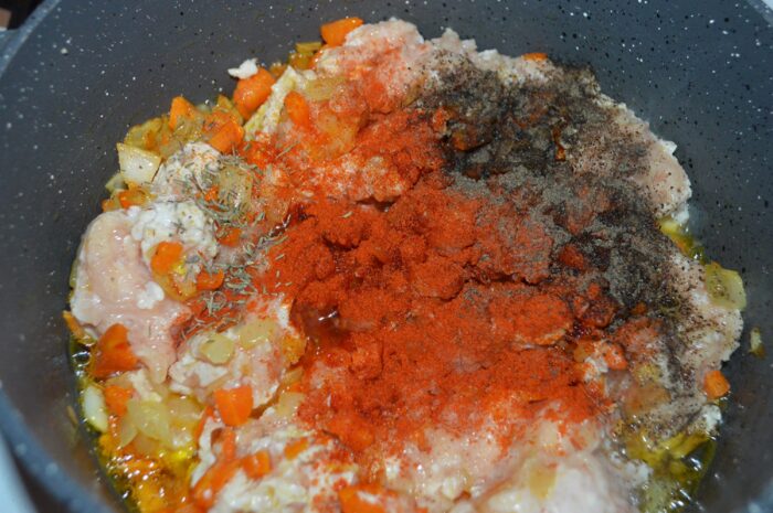Ground chicken mixed with spices and herbs in the pot