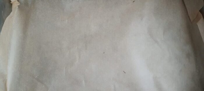 Lining a rimmed baking tray with parchment paper
