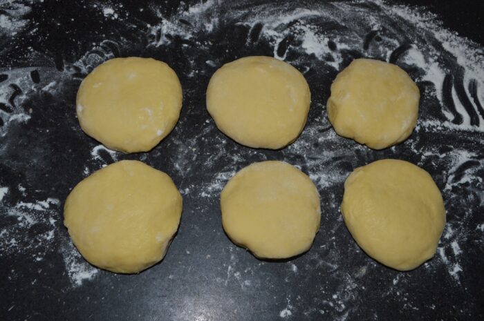 Dough divided into six balls ready to be rolled out