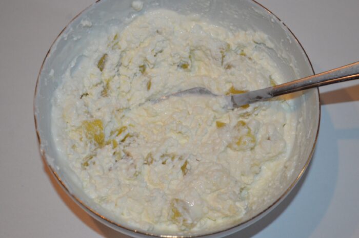 Creamy cheese and yogurt filling mixed with roasted pepper in a bowl
