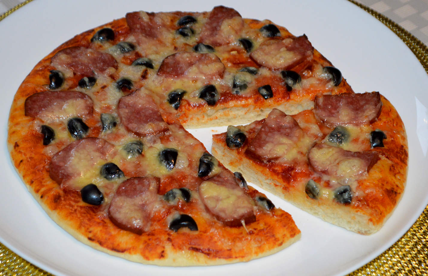 Homemade Pizza with Salami, Cheese and Black Olives
